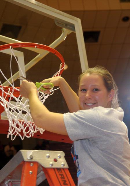 Laura Crittendon, senior, cuts a piece of the net after the Lady Bulldogs defeated Azusa Pacific University to become NAIA Division I National Champions.  - Photo by Morris Abernathy