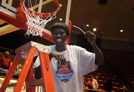 Zeinab Chan, junior, cuts a piece of the net after the Lady Bulldogs defeated Azusa Pacific University to win the NAIA National Tournament.  - Photo by Morris Abernathy