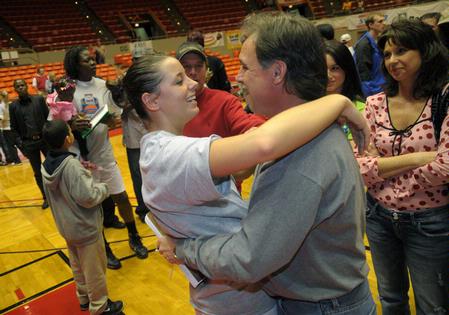 Kaitlin Dudley, senior, celebrates with her family after the Lady Bulldogs won the NAIA National Tournament for the second year in a row.  - Photo by Morris Abernathy