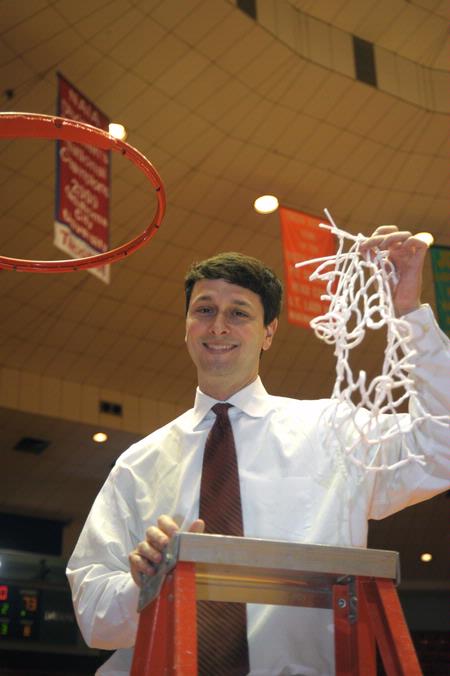 Mark Campbell, head coach, cuts down the rest of the net after the Lady Bulldogs defeated Azusa Pacific University to become NAIA Division I National Champions. - Photo by Morris Abernathy