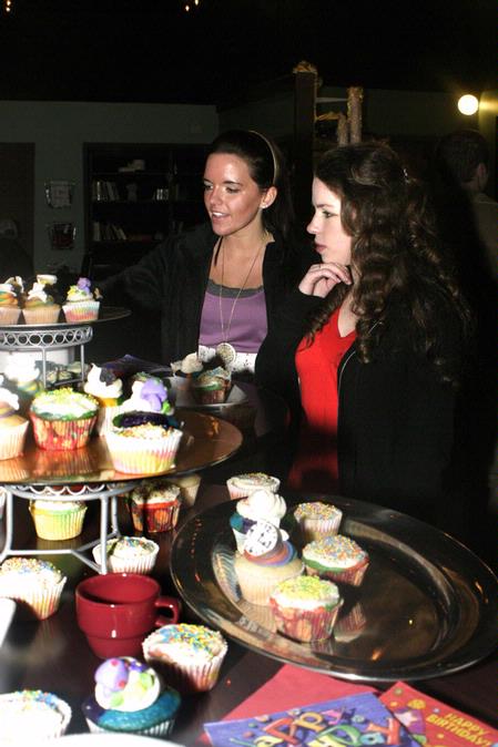 Barefoot's Joe hosted "A Very Merry Unbirthday Party"  in honor of the new "Alice in Wonderland" film. Amanda Rutland, junior education major, and Lauren Ritchie, junior nursing major, enjoy picking out a cupcake. - Photo by Lauren Laster