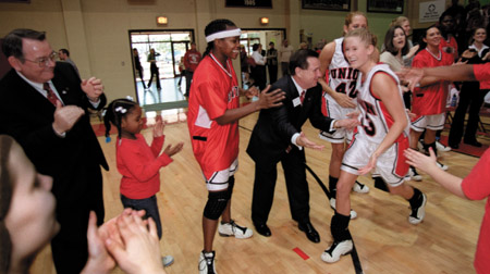 Union Lady Bulldog Mary Catherine Way is cheered by her teammates, Alumni Director Gary Williams, and Chemistry professor Charles Baldwin at the beginning of the Homecoming 2002 game against Trevecca Nazarene. - Photo by Jim Veneman