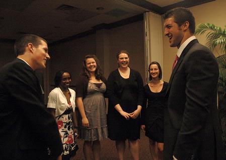 Tim Tebow laughs with Weston Wax, sophomore, after speaking at the Roy L. White Legacy Golf and Gala, April 19. - Photo by Beth Spain