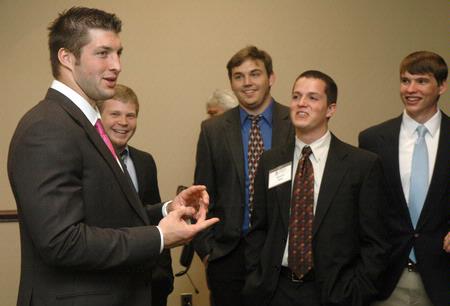 Tim Tebow jokes with several Union University students after the Roy L. White Legacy Golf and Gala, April 19. - Photo by Beth Spain