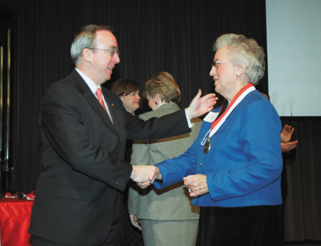President David S. Dockery presents Ramona Mercer ('52) with a special 50-year medallion that was presented to her and each member of the rest of her class during the Founder’s Day Homecoming 2002 Chapel. - Photo by Jim Veneman