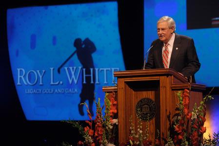 Dr. Roy L. White presents the keynote speaker, Tim Tebow, for the annual Legacy Golf and Gala event. - Photo by Morris Abernathy