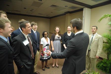 Tim Tebow, keynote speaker at the Roy L. White Legacy Golf and Gala, has a laugh with guests after the event. - Photo by Morris Abernathy