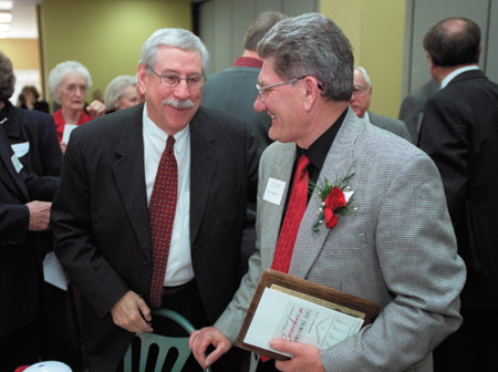 Professor of Education Bill Hedspeth (left) speaks with former Financial Aid Diretor Don Morris after receiving the Distinguished Faculty/Staff Award during Homecoming 2002.  - Photo by Jim Veneman