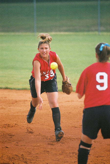 Union second baseman, Crystal Surgalski (33) tosses the ball to first baseman Christina Johnson (9) for the putout. - Photo by Jim Veneman