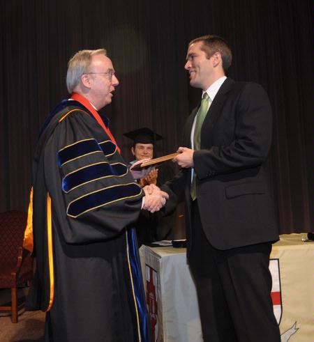 Dr. David S. Dockery, president of Union University, presents Jason Castles, director of student leadership, with the Staff Member of the Year award.  - Photo by Morris Abernathy