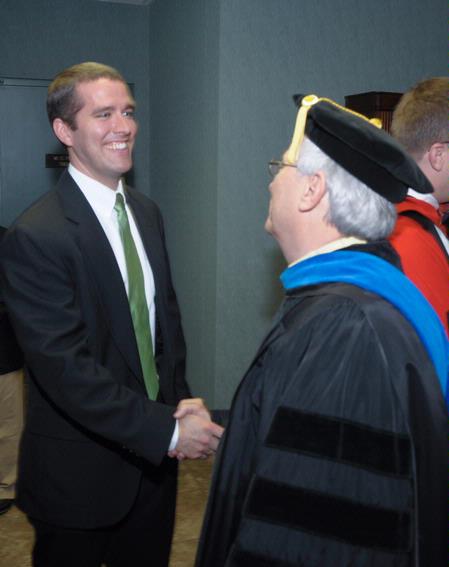 Jason Castles is congratulated by Dr. James Huggins after being named Staff Member of the Year at the Awards Day chapel. - Photo by Morris Abernathy