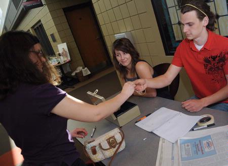 Maggie Ledbetter, sophomore physical education and health major, and Zac Benson, junior art major, work at the Mother's Day Pottery and Art Sale.  - Photo by Morris Abernathy