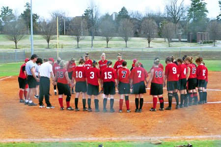 The Union softball team gathers with the opponent for a postgame prayer. - Photo by Kristen Hiller