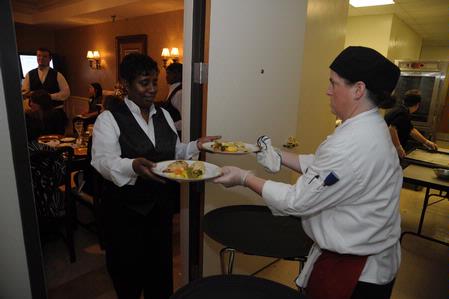 Aramark staff members work hard behind the scenes of the Etiquette Luncheon.  - Photo by Morris Abernathy