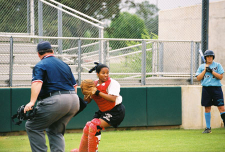 Senior catcher Megan Quarry attempts to through out a runner. - Photo by Kristen Hiller