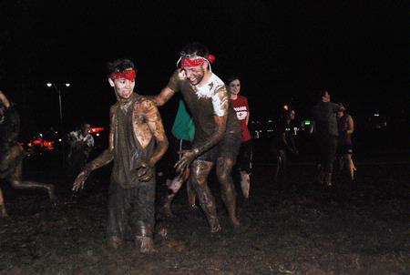 Sophomore music majors Sam Ritter and Chase Techentin channel their inner child at Midnight Mudness sponsored by Young Alums. Students gathered behind the Heritage Complex to celebrate the end of a semester by playing in the mud. - Photo by Abigail Harris
