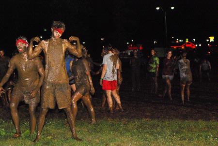 Sam Ritter, sophomore music major, poses covered in mud at the Midnight Mudness event sponsored by Young Alums. Students gathered behind the Heritage Complexes to celebrate the end of a semester by playing in the mud. - Photo by Abigail Harris