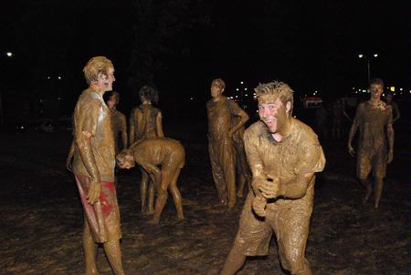 Scott McSwain, senior Spanish major, plays in the mud at Midnight Mudness, sponsored by Young Alums. Students gathered behind the Heritage Complexes to celebrate the end of a semester by playing in the mud. - Photo by Abigail Harris