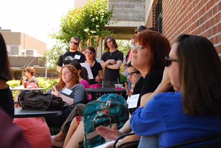 English majors gather outside Barefoots Joe to hear peers read personal work for the annual Scholarship Symposium. - Photo by Abigail Harris
