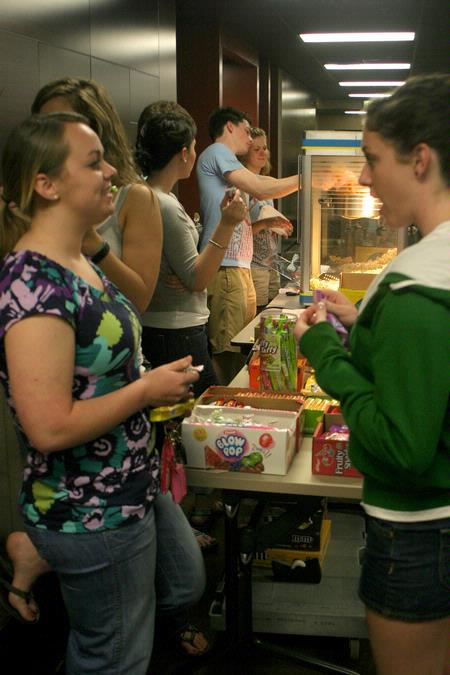 Students enjoy the free snack, drink and bag of popcorn provided by the Student Activities Council during the Movie in the Bowld Student Commons. - Photo by Lauren Laster