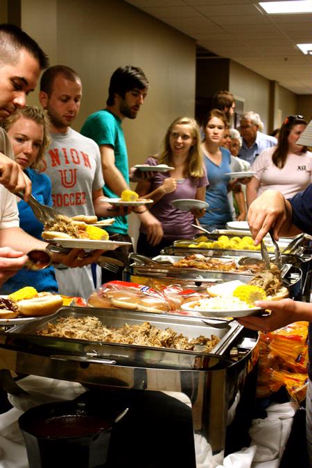 The 2010 graduating seniors pile their plates high with bar-b-que sandwiches and sides at the graduation reception held in their honor.  - Photo by Ebbie Davis