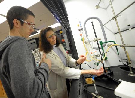 Dr. Sally Henrie, professor of chemistry, helps a student with a lab experiment.  - Photo by Morris Abernathy