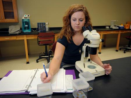 Biology student conducting an experiment. - Photo by Morris Abernathy