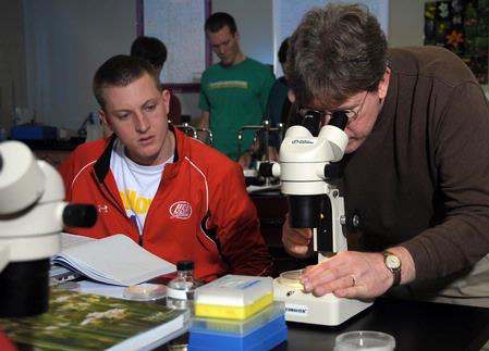 Dr. Mark Bolyard, professor of biology and department chair, helps a student with a biology lab experiment. - Photo by Morris Abernathy