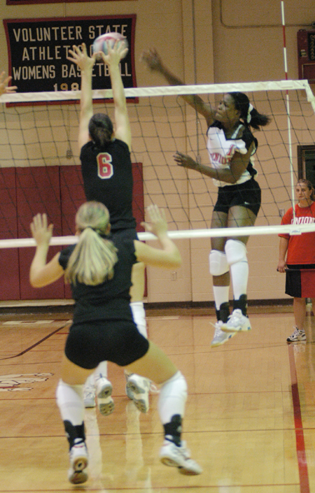 Gladys Wandera (11) goes for a kill.  Wandera is a junior and leads Union in kills and blocks. - Photo by Lindsay Stavish