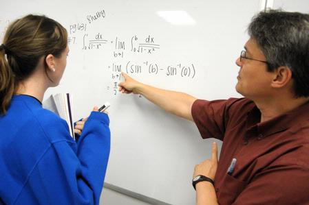 Dr. Troy Riggs, professor of mathematics, helps a student with a math problem. - Photo by Morris Abernathy
