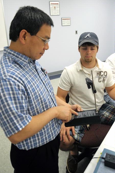Dr. Don Van, professor of engineering and department chair, helps a student in lab. - Photo by Morris Abernathy