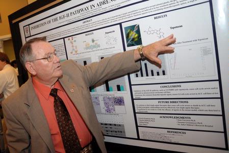 Dr. Charles Baldwin, O.P. and Evalyn Hammons University Professor of Pre-Medical Studies, asks a question about one of the chemistry projects presented at the annual scholarship symposium.  - Photo by Morris Abernathy