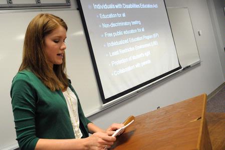 Courtney Bragg, teaching English as a second language major, presents her semester long project for the annual scholarship symposium. - Photo by Morris Abernathy