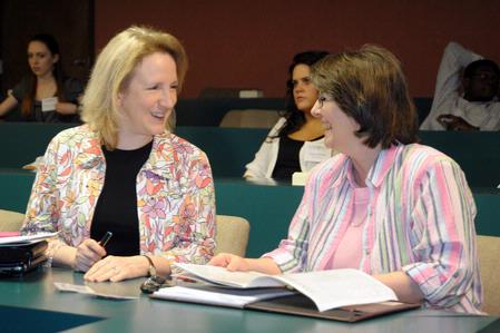Dr. Jeannette Russ and Mary Ann Poe share a laugh as they wait for the presentations to begin at the annual scholarship symposium. - Photo by Morris Abernathy