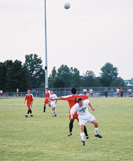 Fabio Buarque (12) fights off a defender as he waits for the ball. - Photo by Uncredited