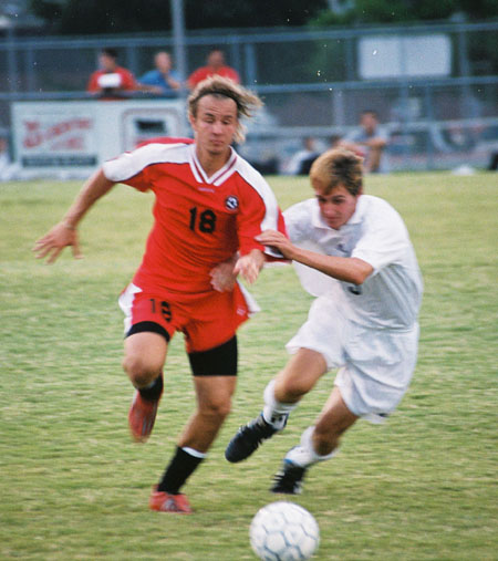 Christopher Printice (18) races for the ball as a defender is with him stride for stride. - Photo by Uncredited