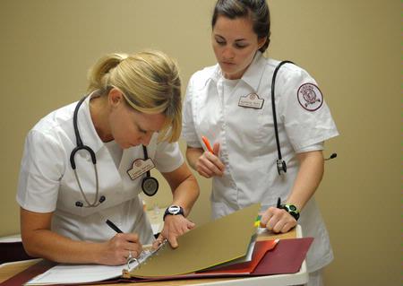 Nursing students work on simulations in Providence Hall. - Photo by Morris Abernathy