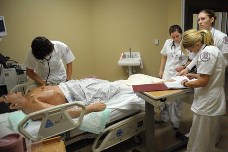 Nursing students work on simulations in Providence Hall. - Photo by Morris Abernathy