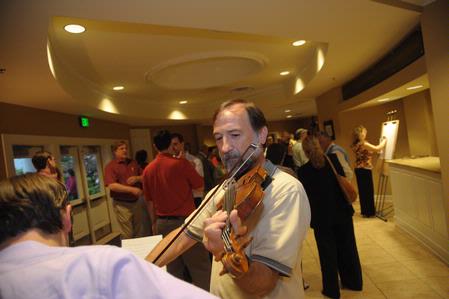Hal Poe, Charles Colson Professor of Faith & Culture, provides a little pre-meal entertainment for faculty and staff at the Faculty/Staff dinner.  - Photo by Morris Abernathy