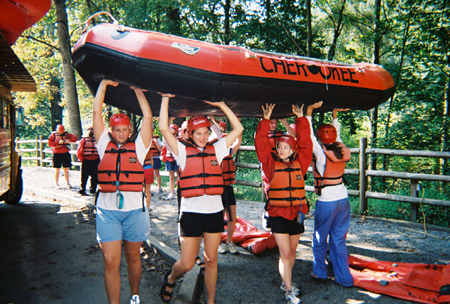 Eager rafters help unload boats shortly before their trip down the Upper and Lower Nolichucky River during the white water rafting Adventure Program. - Photo by Cam Tracy