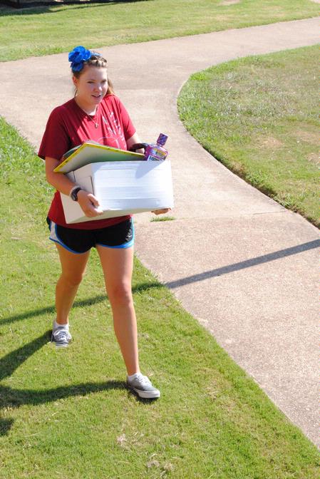 Anika Strand, sophomore, helps out during new student Move In Day. - Photo by Victoria Stargel