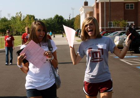 Holly Shea Garland and roommate Shelby Henson, new students from Henderson, TN, show their excitement on new student Move In Day. - Photo by Ebbie Davis