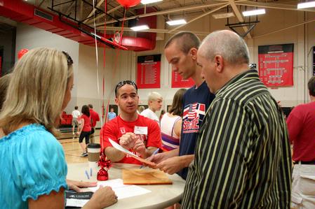 Mark Mogle, an enrollment counselor, assists incoming freshman Taylor LaRue and his parents Kimsey and Mark LaRue from Savannah, Tenn, as they check in on Move In Day.  - Photo by Deanna Santangelo