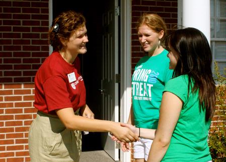 Danae Pacileo, resident advisor, greets new student, Sarah Love from North Carolina, who is living in her building. - Photo by Ebbie Davis