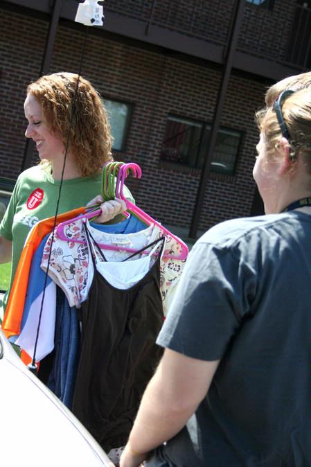Michele Marks, junior social work major, helps incoming freshman, Caitlyn Miller unpack her car during Move In Day. - Photo by Deanna Santangelo