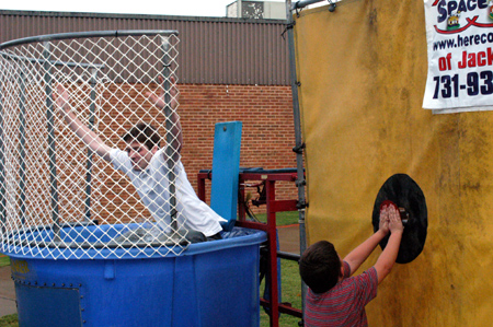 Senior DMS Major Justin Veneman is dunked by Missionary in Residence Tommy and Nancy Tucker's son Zachery. - Photo by Jonathan Blair