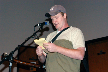 Brad Chad, Christian comedian, studies his notes as he entertains students in Harvey hall during Fall Fest 2003. - Photo by Jonathan Blair