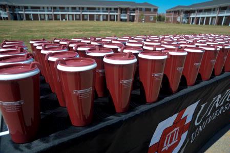 Over two hundred commemorative cups were given out at the dedication of the Hope Residence Complex.  - Photo by Morris Abernathy