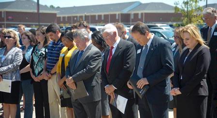 Faculty, staff, and friends of Union bow in prayer during the dedication service for the Hope Residence Complex.  - Photo by Morris Abernathy
