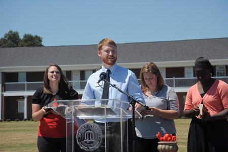 Luke Pruett, residence director, reads scripture at the dedication of the Hope Residence Complex.  - Photo by Morris Abernathy